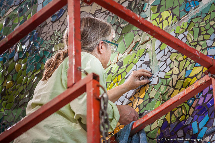 Artist Jennifer McGuire making the piece seamless before the dedication and Grand Opening