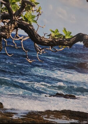 Ocean view Kauai, HI with a Branch going across the top with floral leaves and green. Seaweed washed ashore near the breaking waves - Daniel King